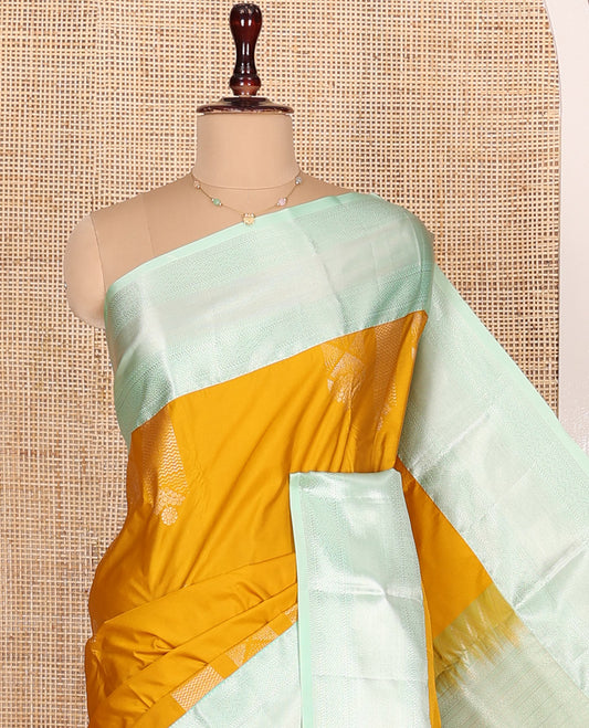 Mustrad Budget Silk Saree, Embellished with Zari Buttas All Over Its Body, Complemented by Contrast Border of Traditional Designs Woven in Zari, Majestically Detailed Pallu, and Paired with a Contrast Blouse