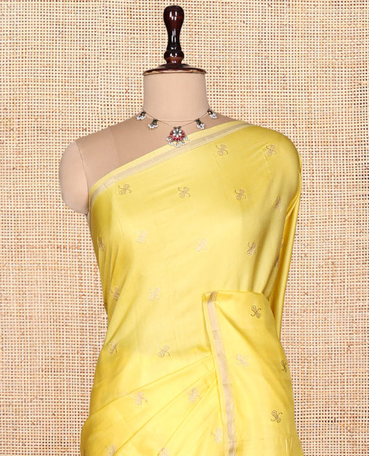 Light Yellow Satin Silk Saree, Subtly Sparkled with Zari Buttas, a Subtle Piping Border, Complemented by a Contrast Intricately Designed Pallu, and a Contrast Blouse