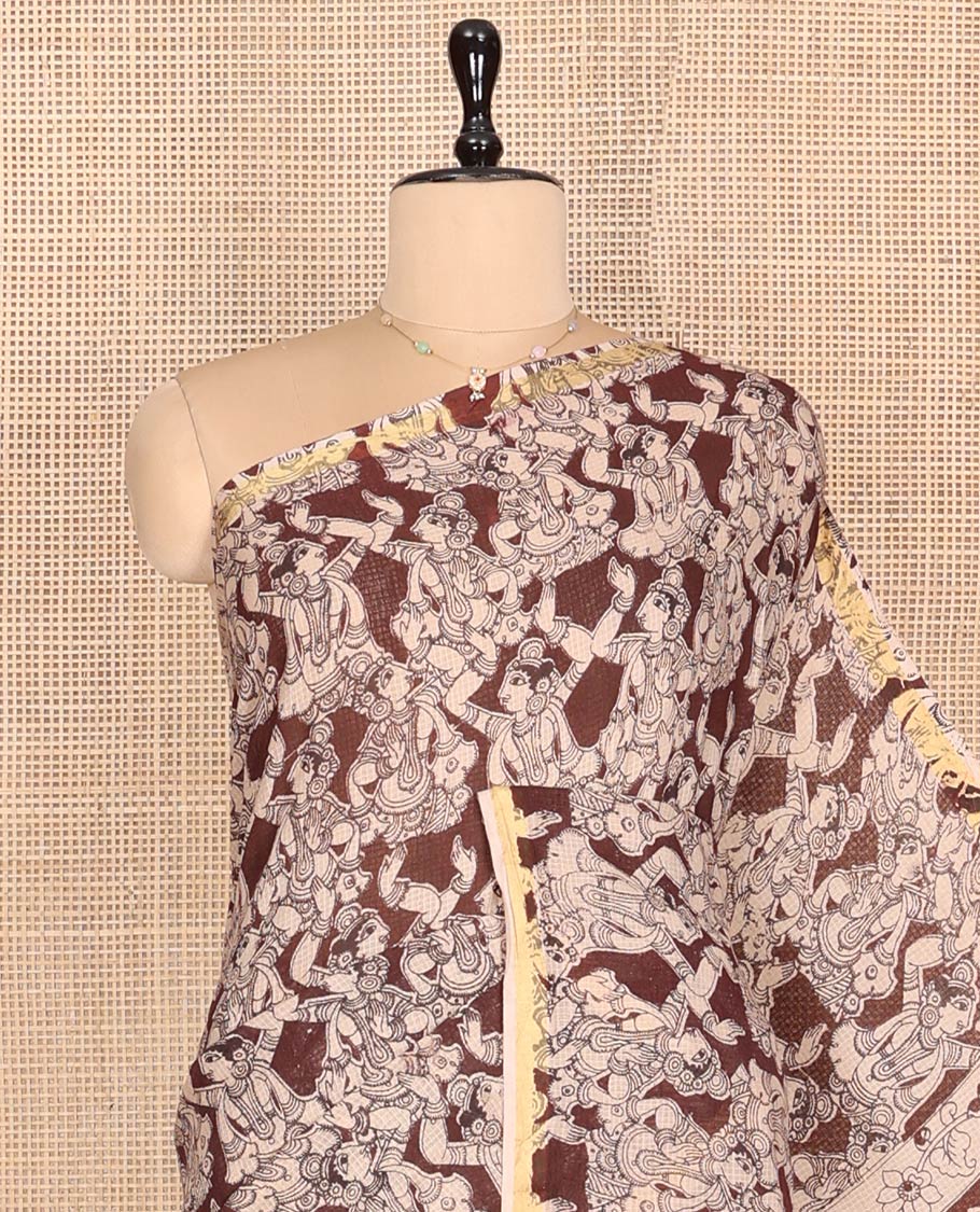 Brown Machine-Printed Kalamkari Cotton Saree Features Human Motifs, a Piping Border, Pallu of Peacocks, and a Matching Blouse
