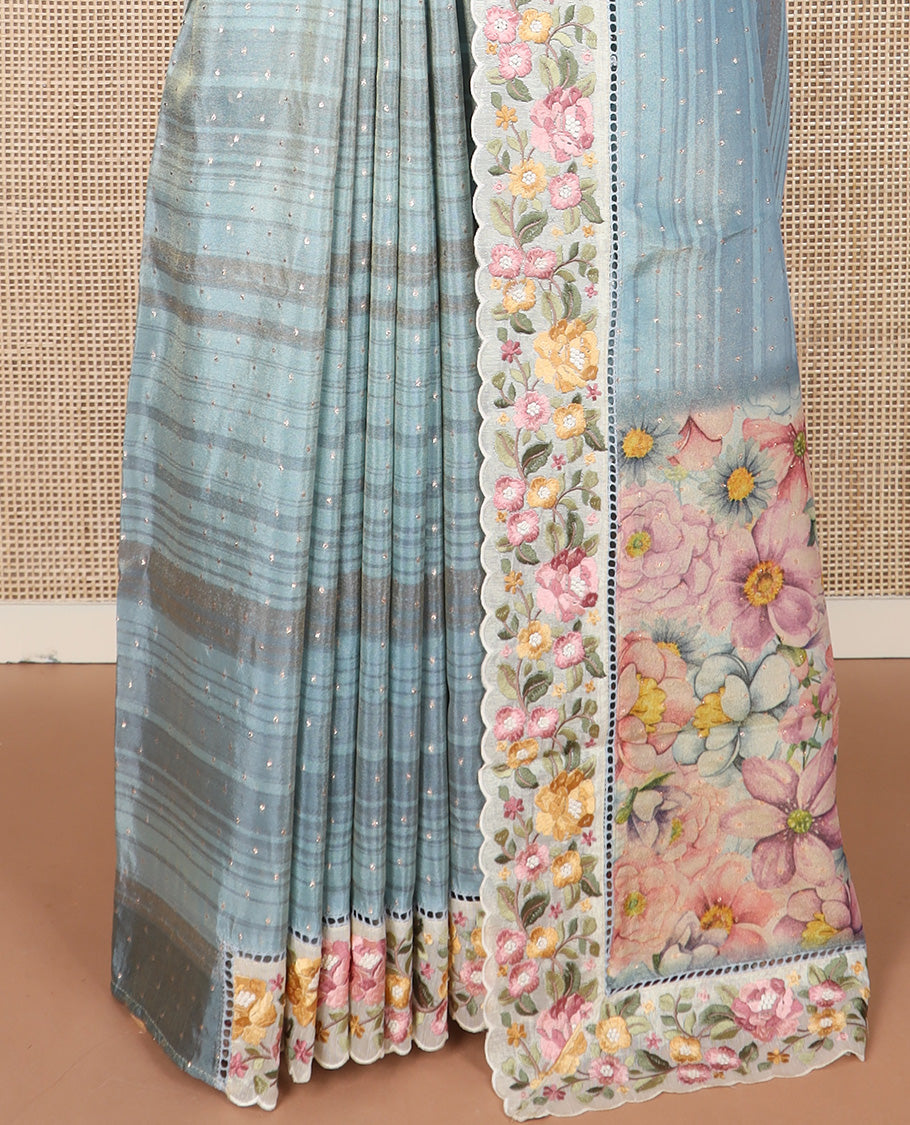 Pastel blue dobby-style buttas dola silk saree, contrast floral embroidered scallop border, and floral printed pallu