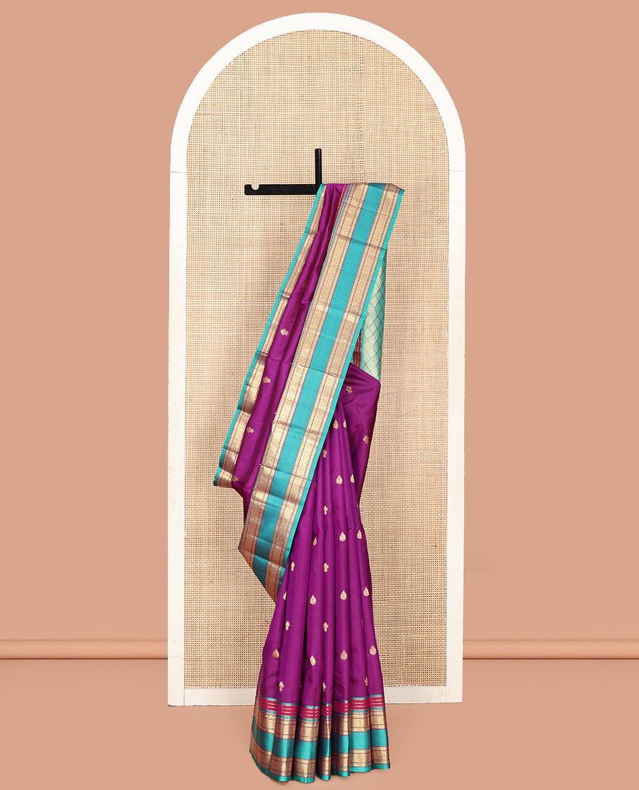 Purple Vasundhara Silk Saree, Beautifully Bedecked with Kamalam Buttas on Its Body, Complemented by a Captivating Contrast Border of Muthu, Chakram, and Mayil Kann Designs, Grand Jaal Pallu, and Paired with a Contrast Blouse