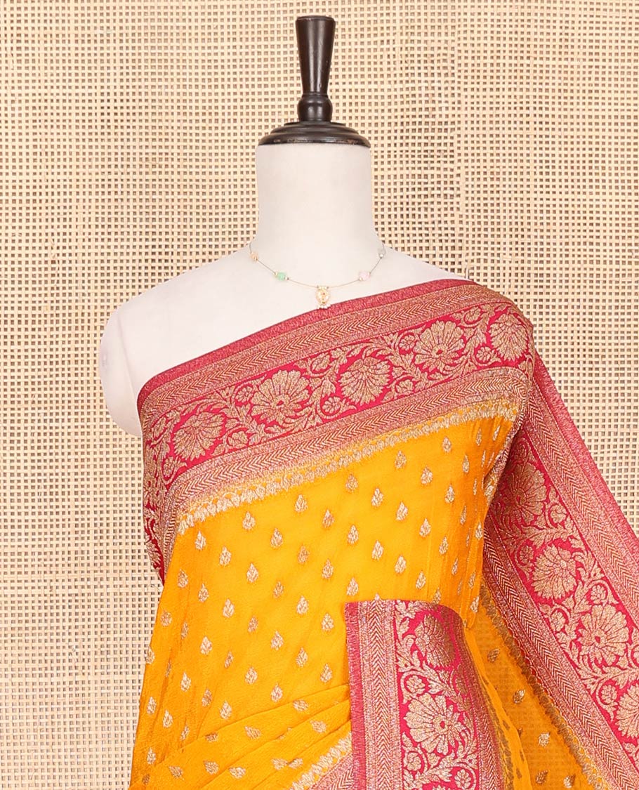 Orange Fancy Georgette Saree Subtly Sparkled with Zari Buttas, Complemented by Contrast Border of Floral  Designs, Zari-Rich Pallu of Floral Jaal Designs, and Paired with a Contrast Blouse