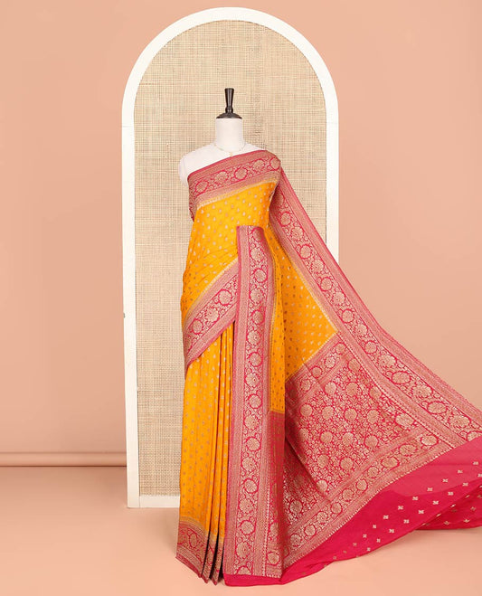 Orange Fancy Georgette Saree Subtly Sparkled with Zari Buttas, Complemented by Contrast Border of Floral  Designs, Zari-Rich Pallu of Floral Jaal Designs, and Paired with a Contrast Blouse