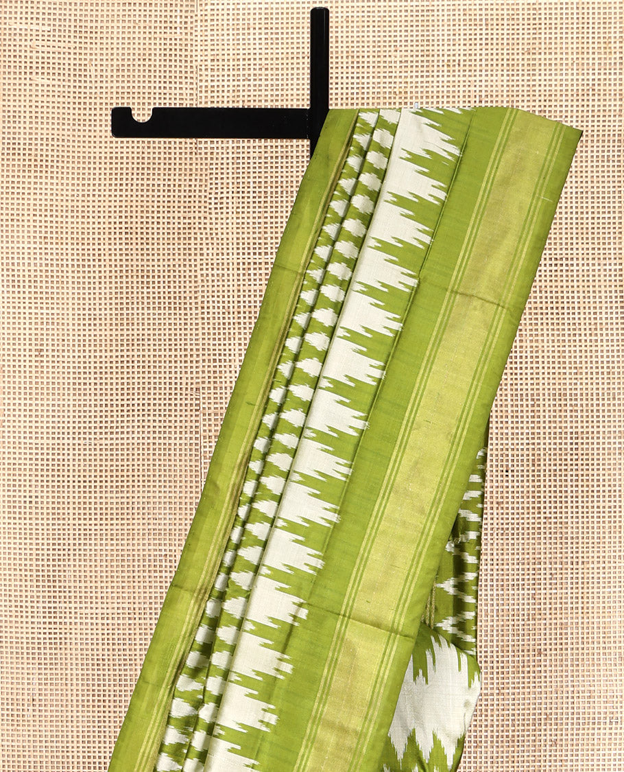 Green Pochampally Ikat Silk Saree, Elevated with Ikkat Buttas on Its Body, Complemented by a Ikkat-Style Woven Temple Border, Pallu of Ogee Patterns, and Paired with a Matching Blouse