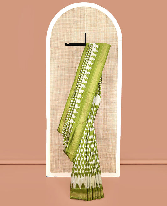 Green Pochampally Ikat Silk Saree, Elevated with Ikkat Buttas on Its Body, Complemented by a Ikkat-Style Woven Temple Border, Pallu of Ogee Patterns, and Paired with a Matching Blouse