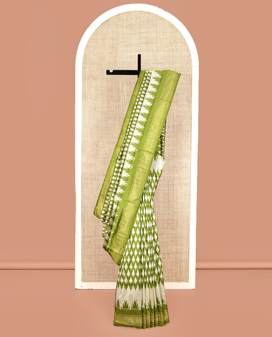 Green Pochampally Ikat Silk Saree, Elevated with Ikkat Buttas on Its Body, Complemented by a Ikkat-Style Woven Temple Border, Pallu of Ogee Patterns, and Paired with a Matching Blouse