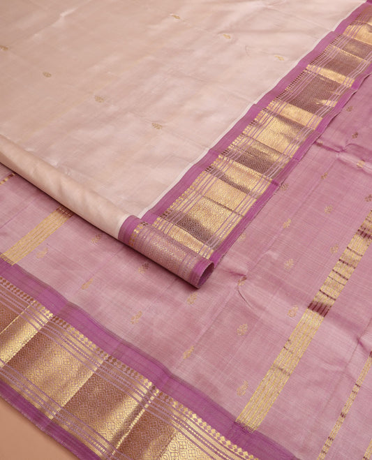 Pale pink zari buttas Kanchipuram silk saree, contrast border of banaras, muthu, and jaal designs, and zari design pallu