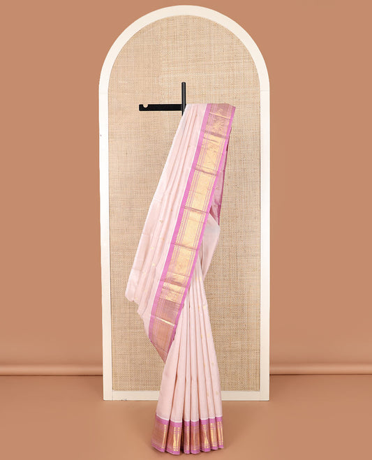 Pale pink zari buttas Kanchipuram silk saree, contrast border of banaras, muthu, and jaal designs, and zari design pallu