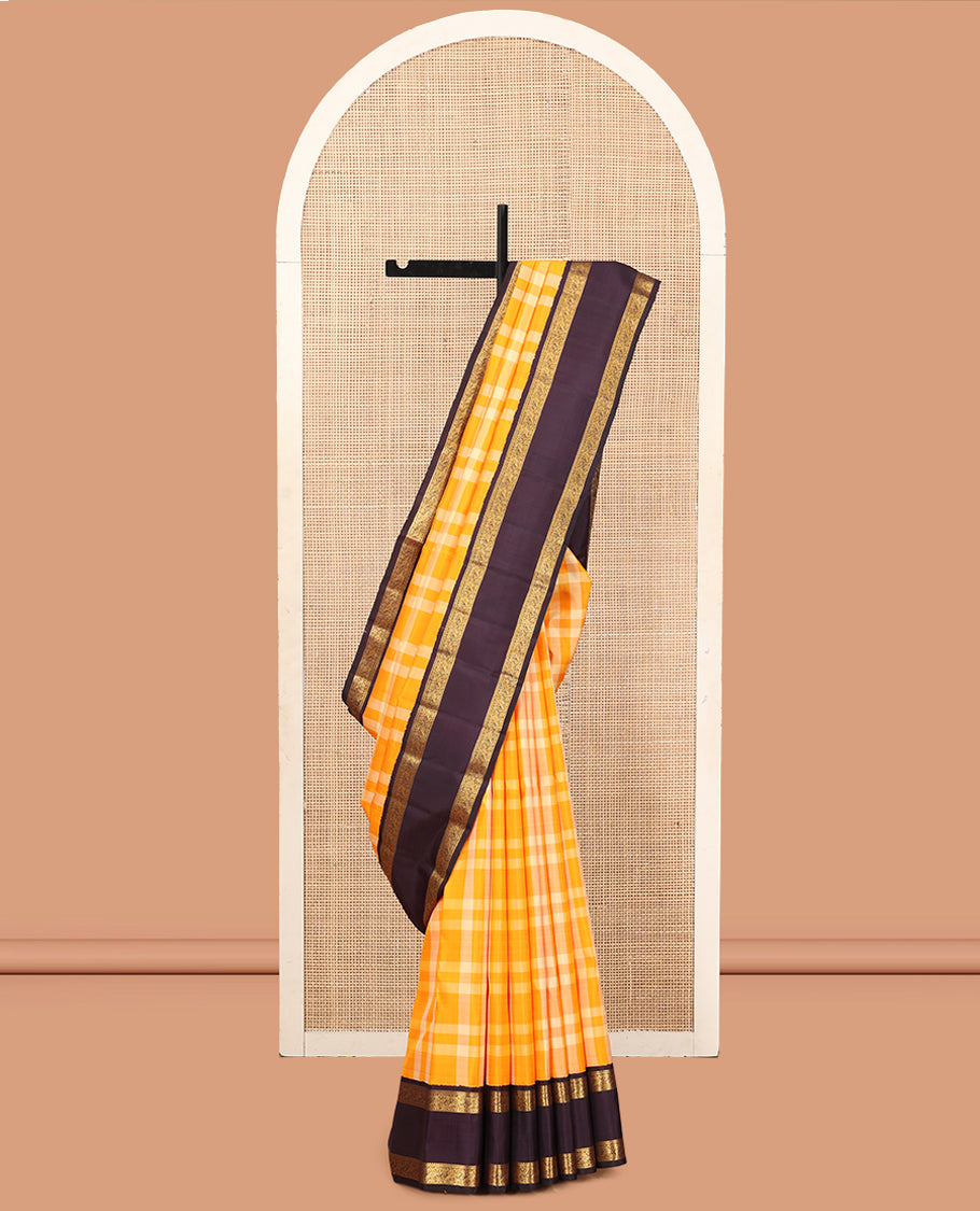 Orange Checked Kanchipuram Silk Saree, Complemented by a Contrast Korvai Rettai Pettu Border of Mayil Designs, Zari Striped Pallu, and a Contrast Blouse
