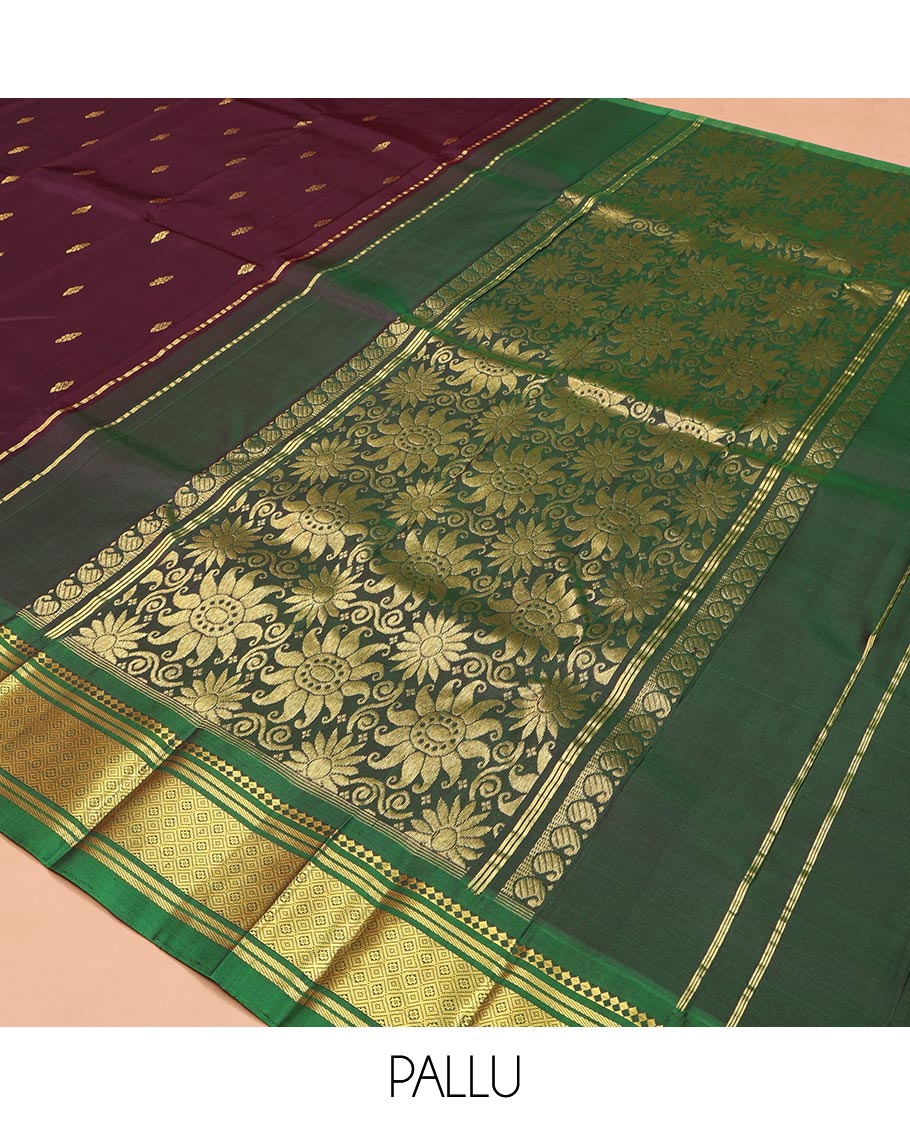 Maroon Kanchipuram Silk Saree, Spotlighted with Zari Buttas on Its Body, Complemented by a Contrast One-Sided Border of Panner Sombu, Banaras, and Jaal Designs, Pallu Features Floral Zari Designs, and Comes Without a Blouse