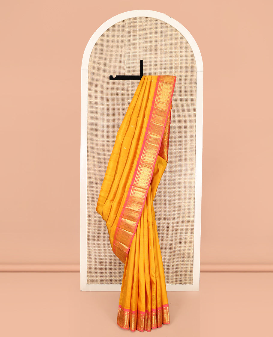 Orange Kanchipuram Silk Saree, Subtly Woven with Zari Buttas, Complemented by Contrast One-Sided Border of Thilakam Mokku, Banaras, Muthu, and Jaal Designs, Zari Design Pallu, and No Blouse