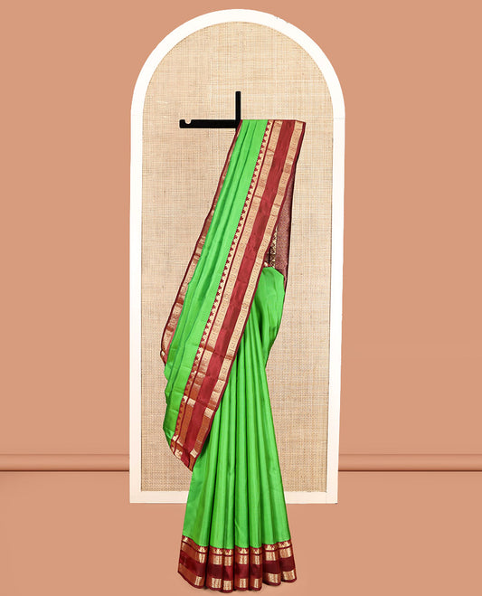 Green Plain Kanchipuram Silk Saree, Complemented by a Contrast Rettai Pettu Border of Thazampoo Rekku, Neli, Kuthirai, and Chakram Designs, Jaal Pallu, and a Contrast Blouse
