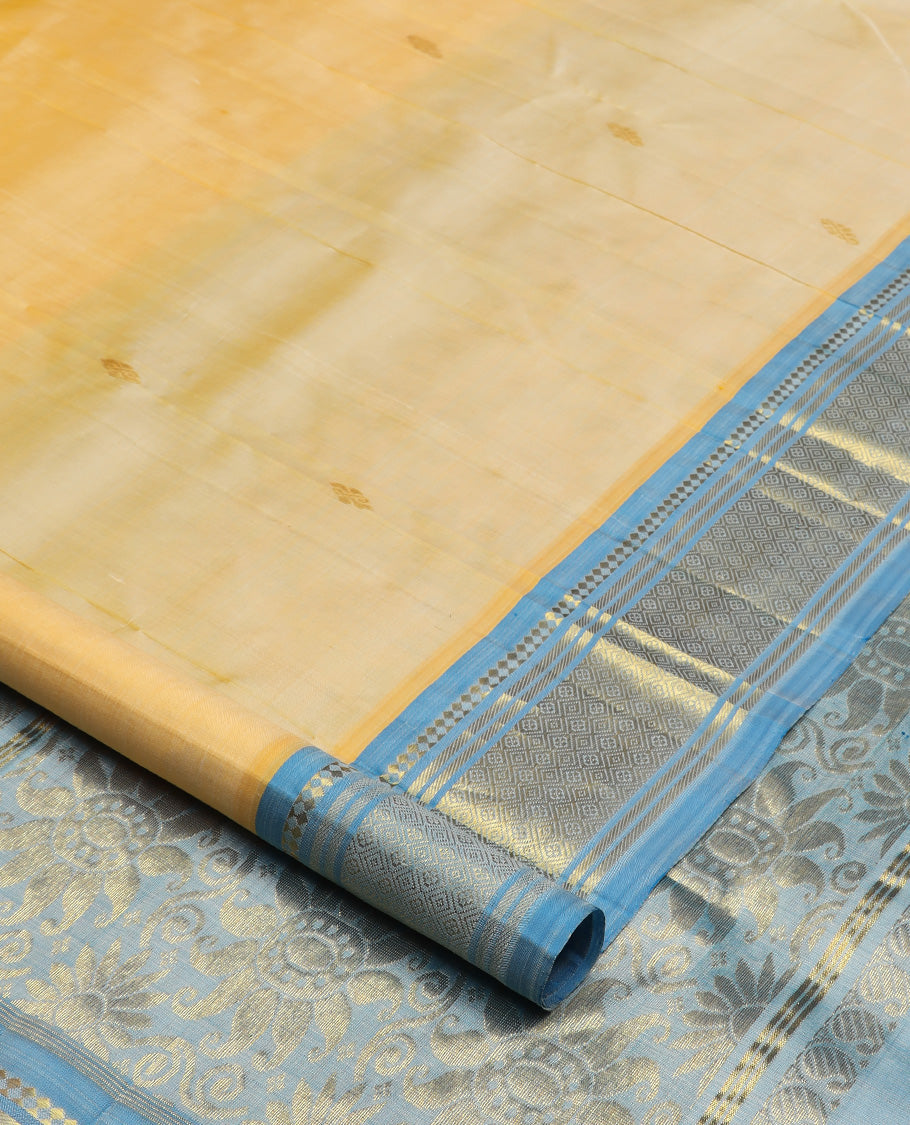 Yellow zari buttas Kanchipuram silk saree, contrast one-sided border of paneer sombu, banaras, and jaal design, and floral design pallu