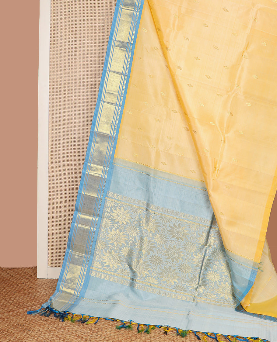 Yellow zari buttas Kanchipuram silk saree, contrast one-sided border of paneer sombu, banaras, and jaal design, and floral design pallu