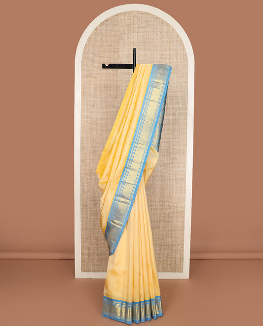 Yellow zari buttas Kanchipuram silk saree, contrast one-sided border of paneer sombu, banaras, and jaal design, and floral design pallu