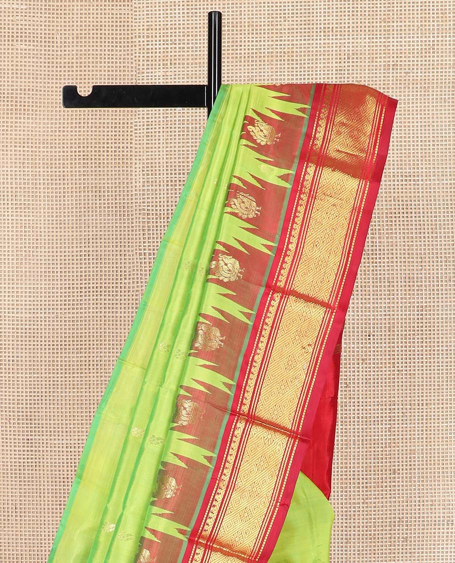 Green zari buttas Kanchipuram silk saree, contrast one-sided thazampoo rekku border of muthu, banaras, and jaal designs, and zari design pallu