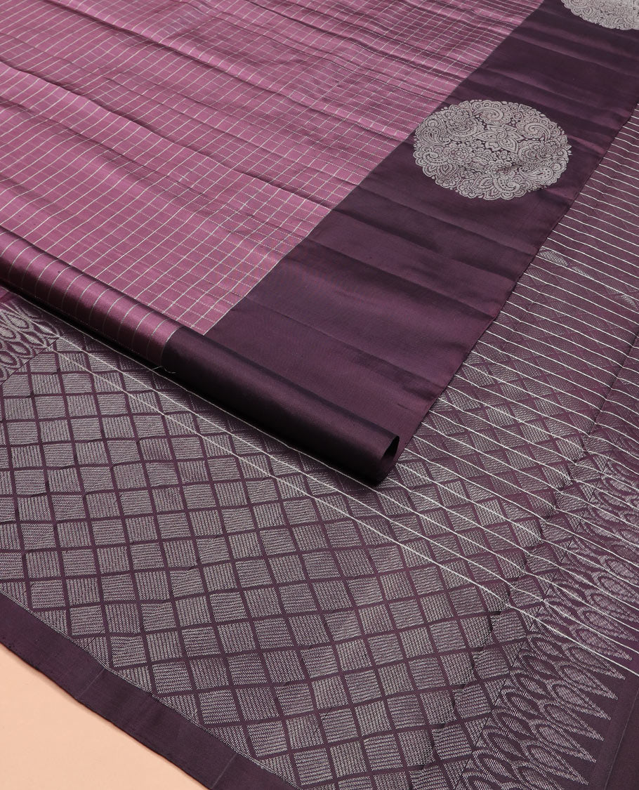Purple checked Kanchipuram silk saree, contrast border of round-chakram style buttas, and paiyaadi kattam pallu