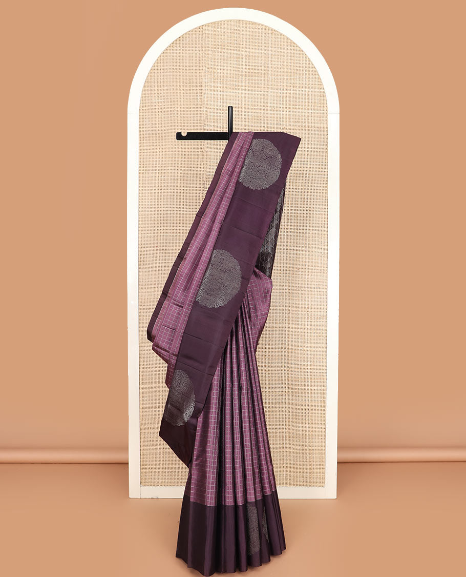 Purple checked Kanchipuram silk saree, contrast border of round-chakram style buttas, and paiyaadi kattam pallu