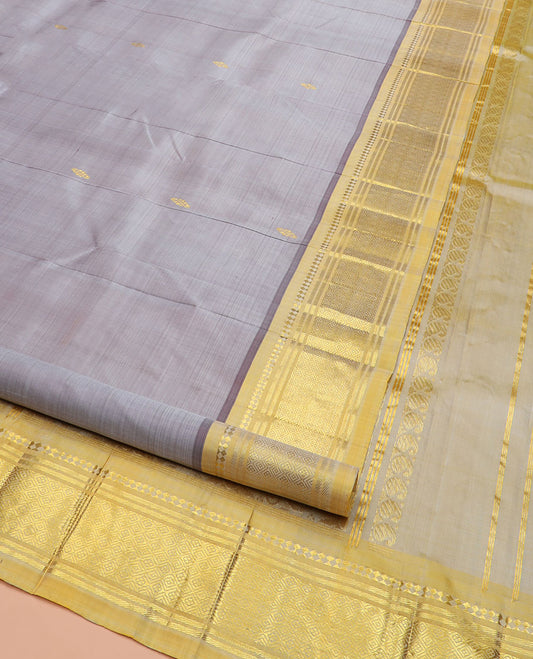 Grey Kanchipuram Silk Saree Detailed with Zari Buttas, Highlighted by Contrast One-Sided Border of Paneer Sombu, Banaras, and Jaal Designs, Pallu Accentuated with Floral Zari Design, and Comes Without a Blouse