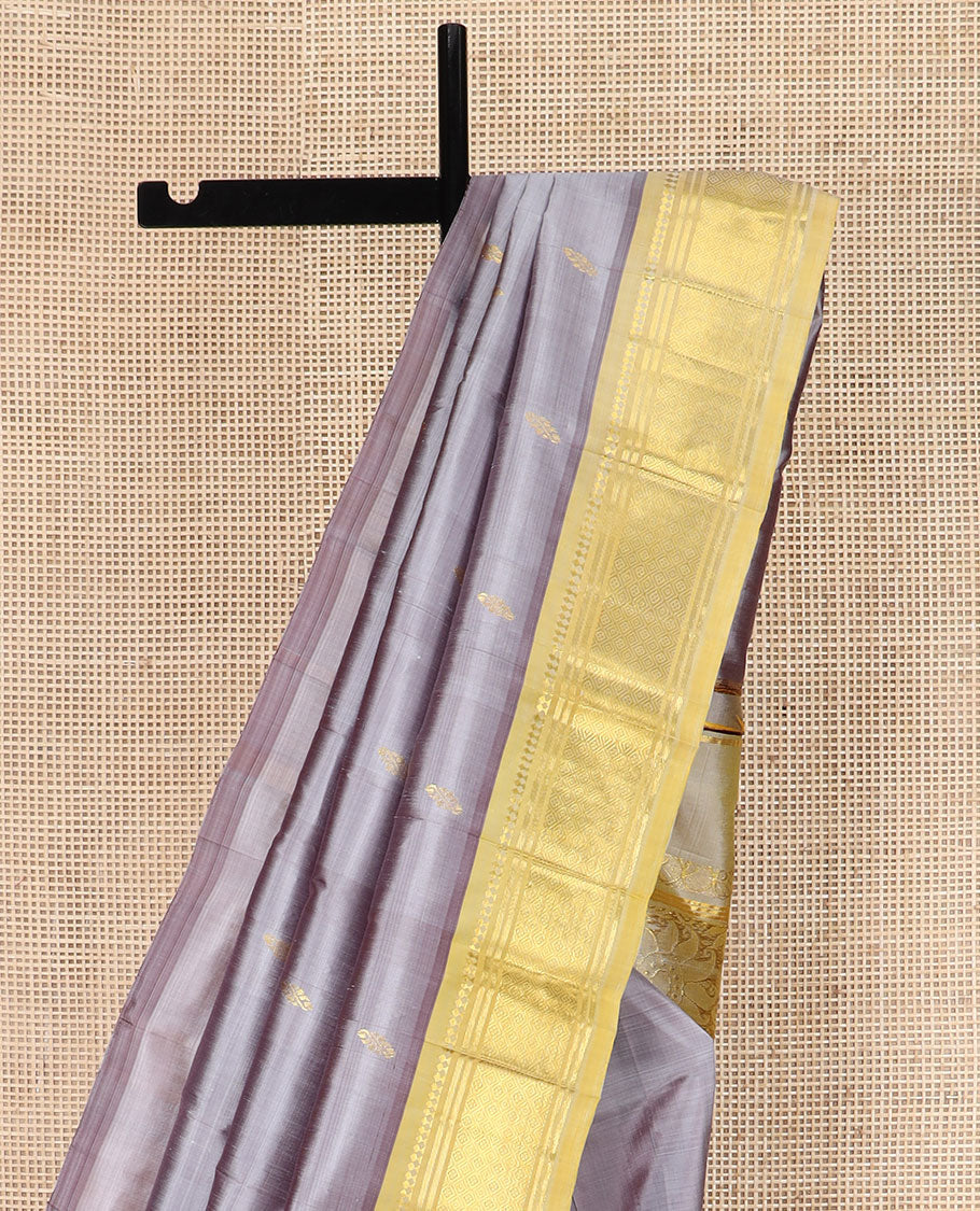 Grey Kanchipuram Silk Saree Detailed with Zari Buttas, Highlighted by Contrast One-Sided Border of Paneer Sombu, Banaras, and Jaal Designs, Pallu Accentuated with Floral Zari Design, and Comes Without a Blouse