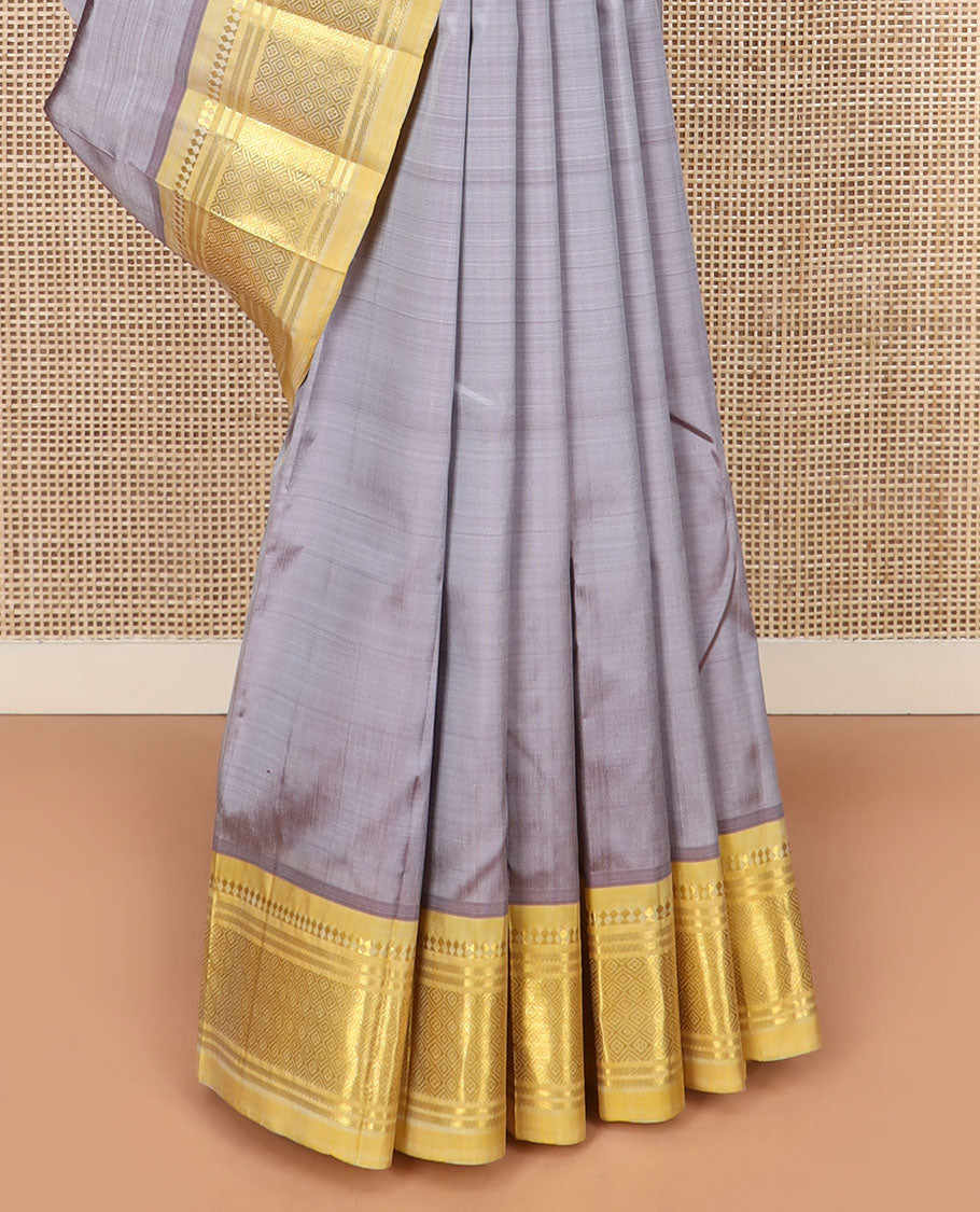 Grey Kanchipuram Silk Saree Detailed with Zari Buttas, Highlighted by Contrast One-Sided Border of Paneer Sombu, Banaras, and Jaal Designs, Pallu Accentuated with Floral Zari Design, and Comes Without a Blouse