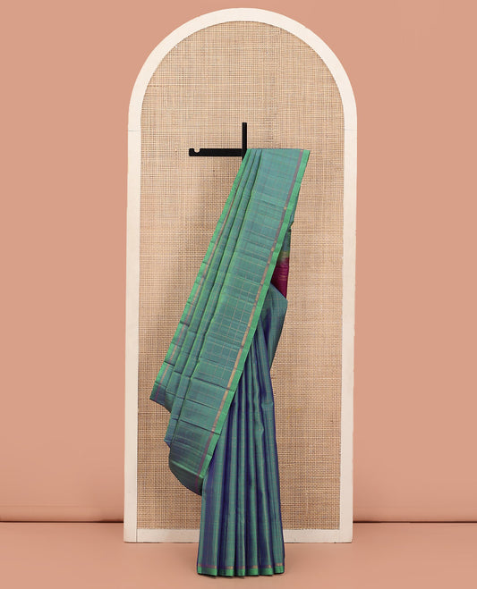 Green Kanchipuram Silk Saree Subtly Sparkled with Stripes, Zari Border, Captivating Contrast Pallu of Zari Stripes, and Paired with a Contrast Zari Striped Blouse