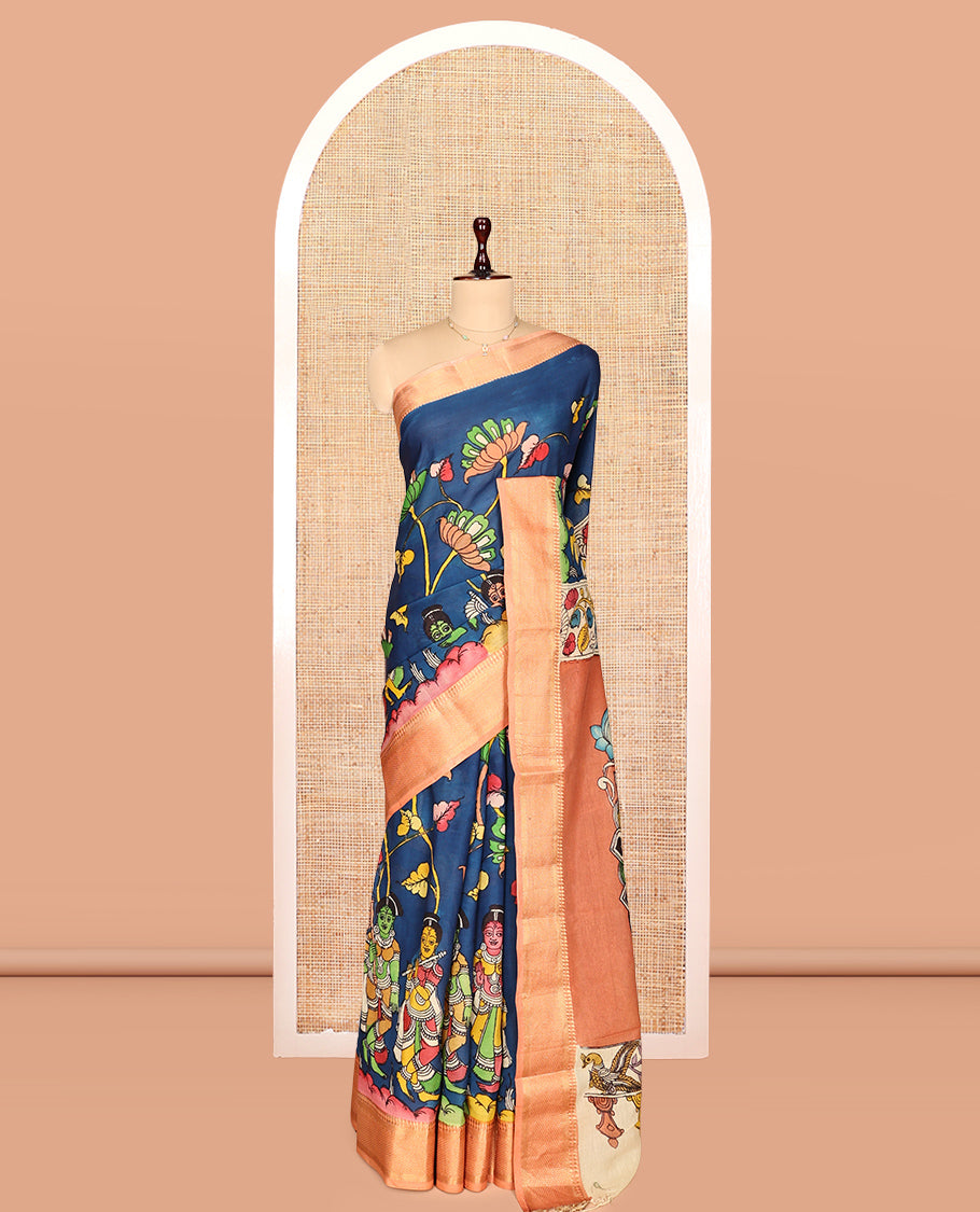 Blue Kalamkari Silk Saree, Opulently Embellished with Floral Vine and Ancient Human Motifs Print, a Contrast Traditional Zari Border, Pallu Features Peacock, and a Contrast Blouse