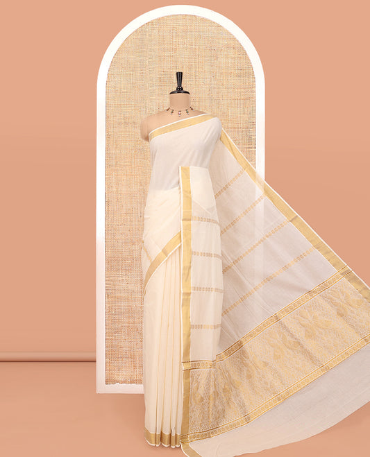 Cream Kerala Cotton Saree, Detailed with Zari Stripes All Over Its Body, a Subtle Bavanji Border, Pallu Features Peacock Designs, and Paired with a Matching Blouse