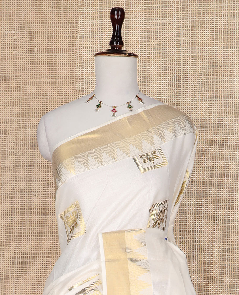 Cream zari Pichwai lotus buttas Kerala saree, zari temple border, and pallu of Pichwai lotus motifs
