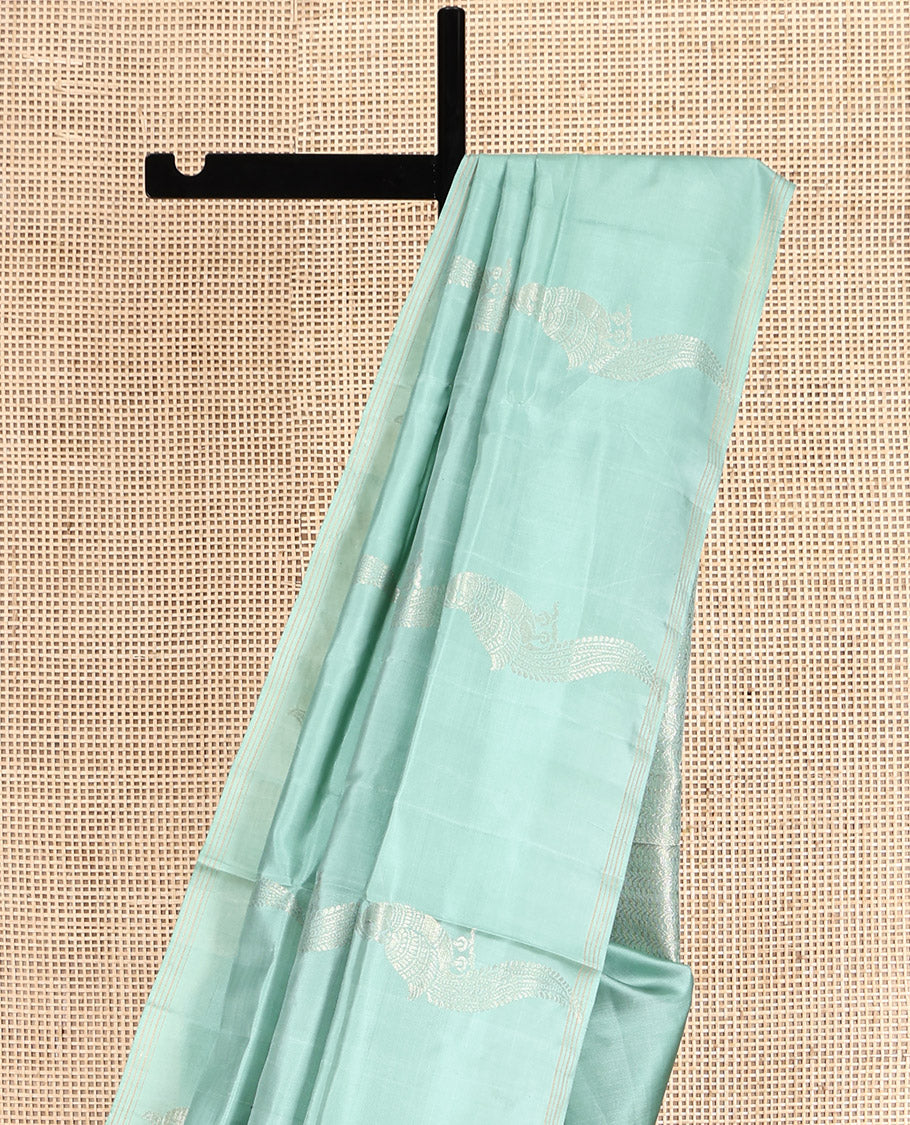Pale Green Mayuri Soft Silk Saree, Beautifully Bedecked with Kili Buttas, a Subtle Piping Border, Sparsely Woven Pallu, and a Matching Blouse