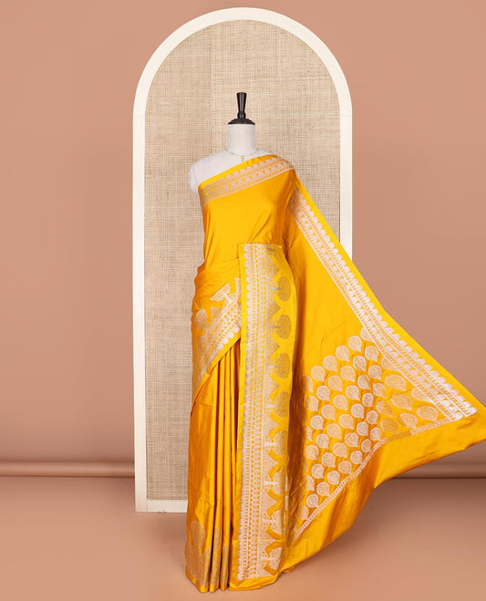 Yellow plain mushru silk saree, self-border of scallop design, floral, and tree motifs, and intricately designed pallu