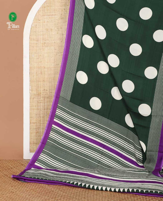 Cream with green polka dot printed gajji silk saree with contrast piping border & printed pallu along with striped printed blouse