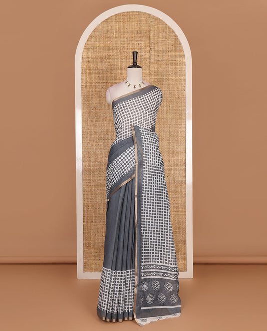 Grey plain and polka dots printed linen cotton saree with piping zari border, floral-geometric print pallu, and contrast flower buttas printed  blouse