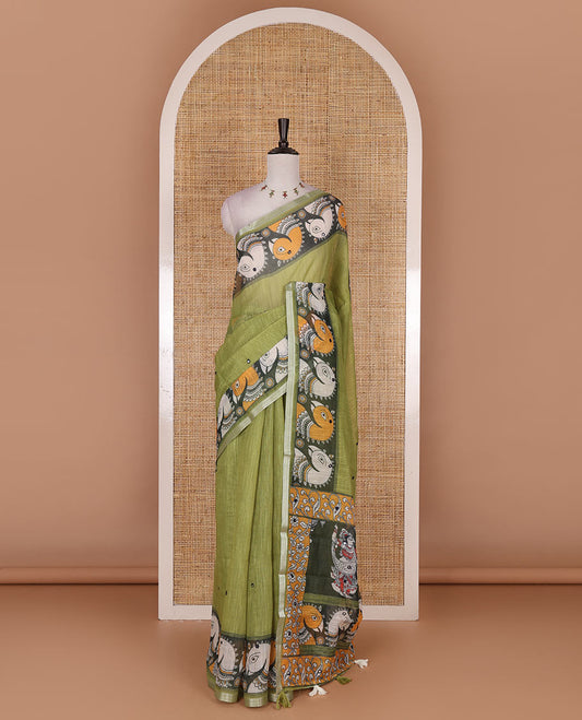 Green mirror thread embroidered linen saree, contrast kalamkari peacock printed border, pallu of kalamkari peacock and human figurines print, and printed blouse