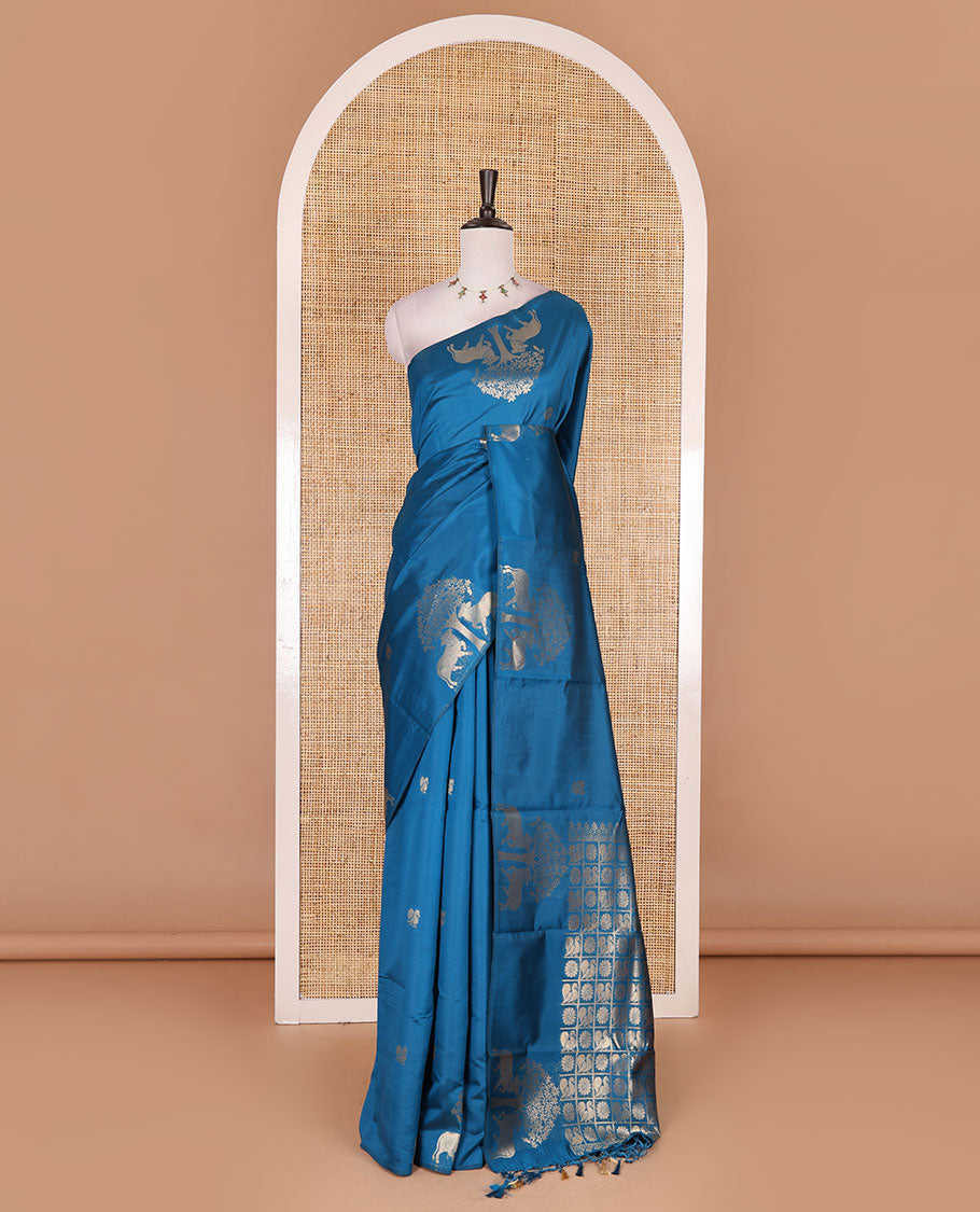 Borderless rama blue peacock, chakra, and pichwai cow buttas zari woven kanchi silk saree, peacock and chakra enclosed checked pallu, and matching blouse