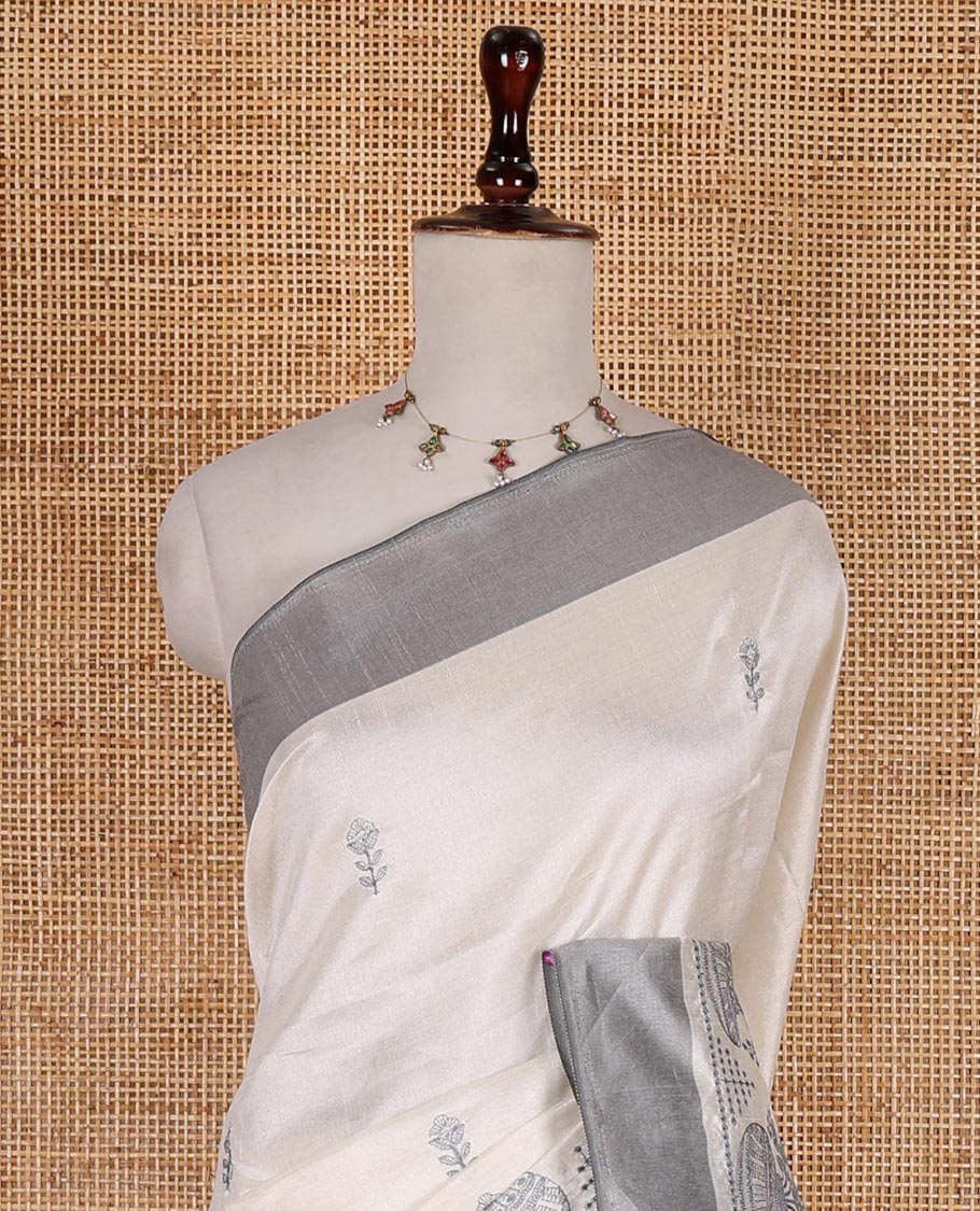 Half-white flower and flower pots motifs thread embroidered semi-tussar saree, contrast grey border, flower motif embroidered pallu, and a matching blouse