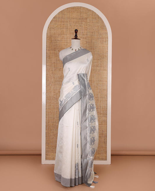 Half-white flower and flower pots motifs thread embroidered semi-tussar saree, contrast grey border, flower motif embroidered pallu, and a matching blouse
