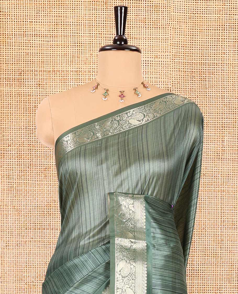 Green striped semi-tussar saree, traditional zari border of floral creeper designs, contrast pallu of Pichwai cow print, and contrast Pichwai cow printed blouse
