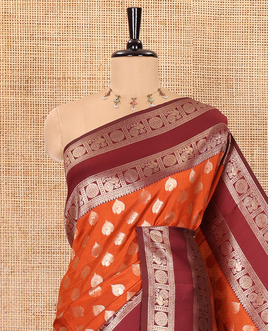 Rust orange zari buttas kanchi silk saree, contrast traditional rettai pettu border of peacock chakram, intricate pallu, and a zari design pallu