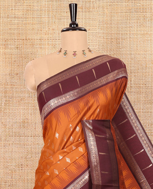 Rust Orange Soft Silk Saree Embellished with Diamond Buttas Woven All Over Its Body, Highlighted with a Contrast Traditional Zari Design Temple Border, Meticulously Woven Pallu of Intricate Designs, and Paired with a Contrast Zari Design Blouse