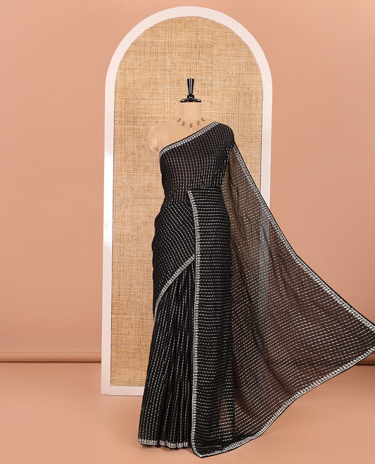 Black Vitchitra Silk Saree Prettified with Sequin-Style Foil Prints All Over Its Body, Jarkan Stone Work Border, and Paired with a Matching Jarkan Stone Work Blouse