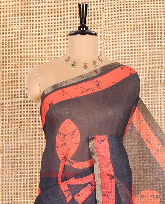 Black Linen Cotton Saree Highlighted with Batik-Style Fancy Vines Printed All Over Its Body, Simply Made with a Contrast Batik Printed Zari Border, Pallu of Stripes and Batik Print, and Paired with a Matching Blouse