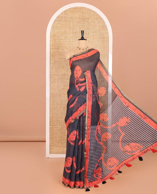 Black Linen Cotton Saree Highlighted with Batik-Style Fancy Vines Printed All Over Its Body, Simply Made with a Contrast Batik Printed Zari Border, Pallu of Stripes and Batik Print, and Paired with a Matching Blouse