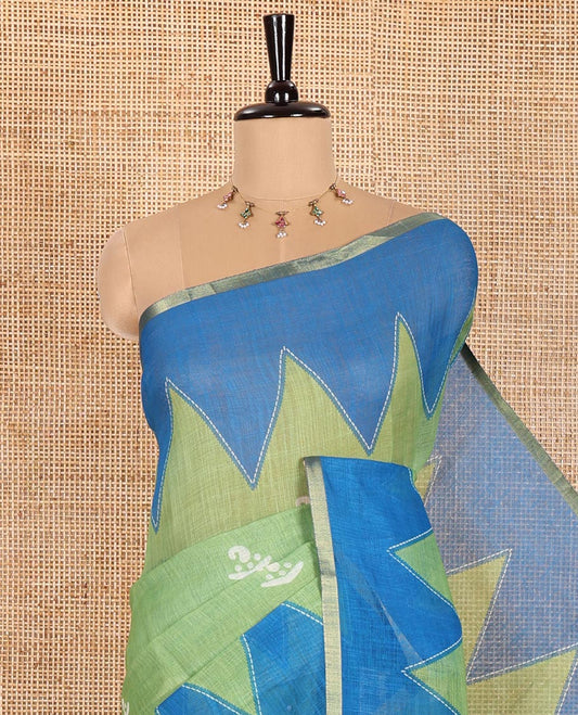 Green Linen Cotton Saree Decorated with Batik-Style Buttas Printed All Over Its Body, Complemented by a Contrast Temple Zari Piping Border, Striped Pallu, and Paired with a Matching Striped Blouse