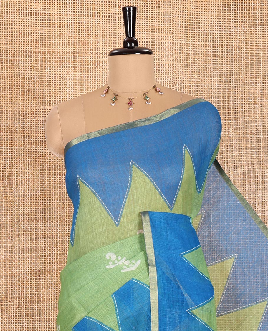 Green Linen Cotton Saree Decorated with Batik-Style Buttas Printed All Over Its Body, Complemented by a Contrast Temple Zari Piping Border, Striped Pallu, and Paired with a Matching Striped Blouse