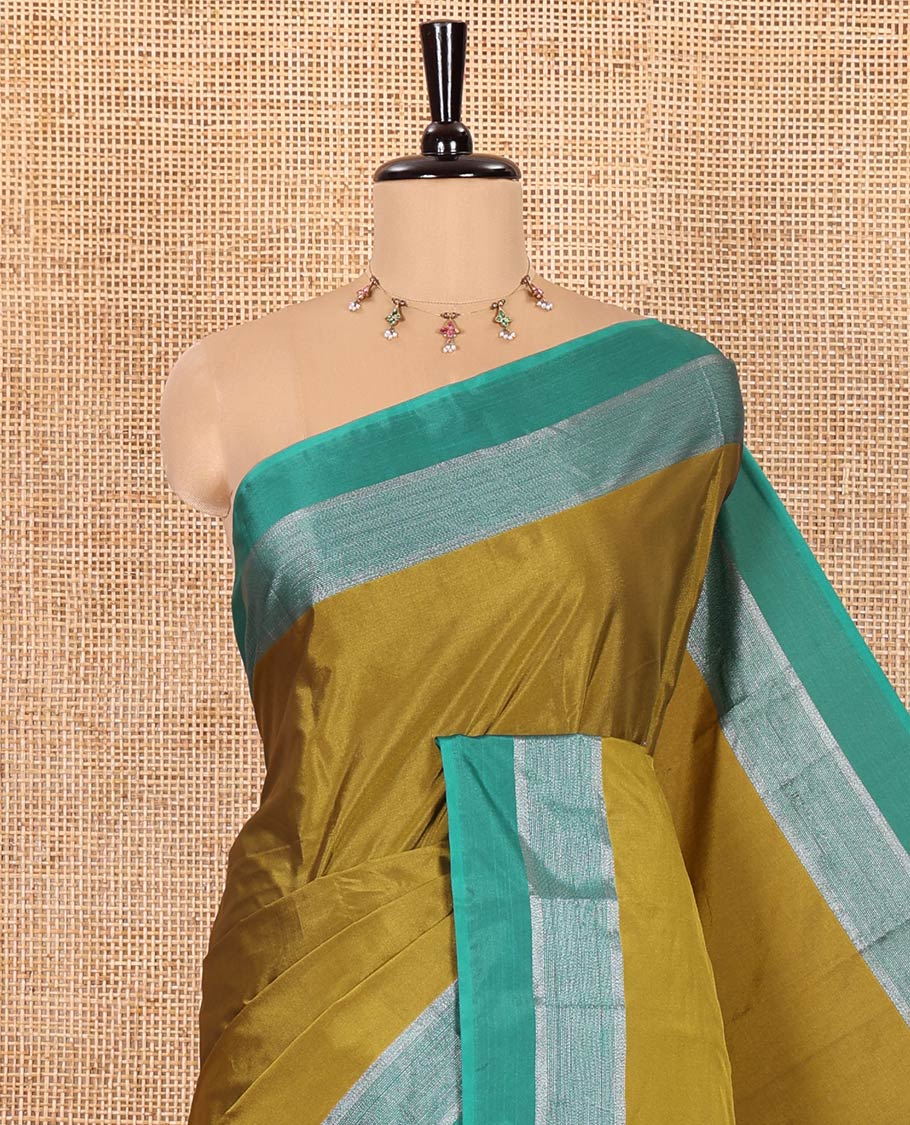 Mehenti Plain Semi-Soft Silk Saree, Complemented by a Contrast Silver Zari Striped Border, Sparsely Striped Pallu, and Paired with a Matching Blouse