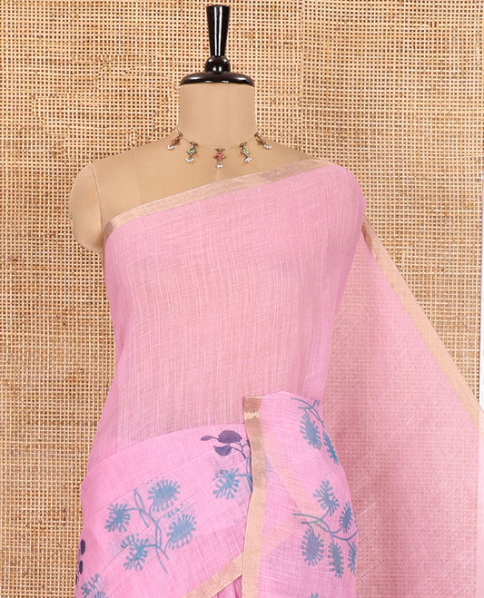Pink Linen Saree, Adorned with Floral Motifs Printed on Its Body, a Subtle Piping Border, Pallu Steeped with Floral Motifs and Stripes, and Paired with a Contrast Blouse