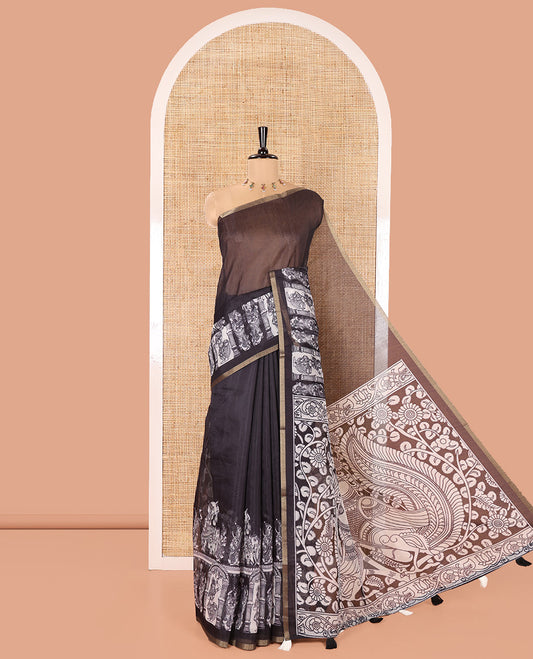 Black Chanderi Cotton Saree, Detailed with Kalamkari-Style Ancient Human Figurines Printed on Its Body, Subtle Zari Piping Border, Pallu Depicting Kalamkari Peacocks, and Paired with a Matching Blouse