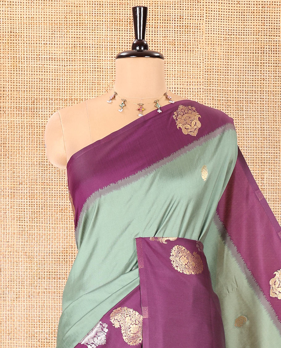 Green Elite Soft Silk Saree, Elevated with Zari Buttas All Over Its Body, Complemented by Contrast Border Steeped with Zari Buttas, Grand Jaal Design Pallu, and Paired with a Contrast Blouse