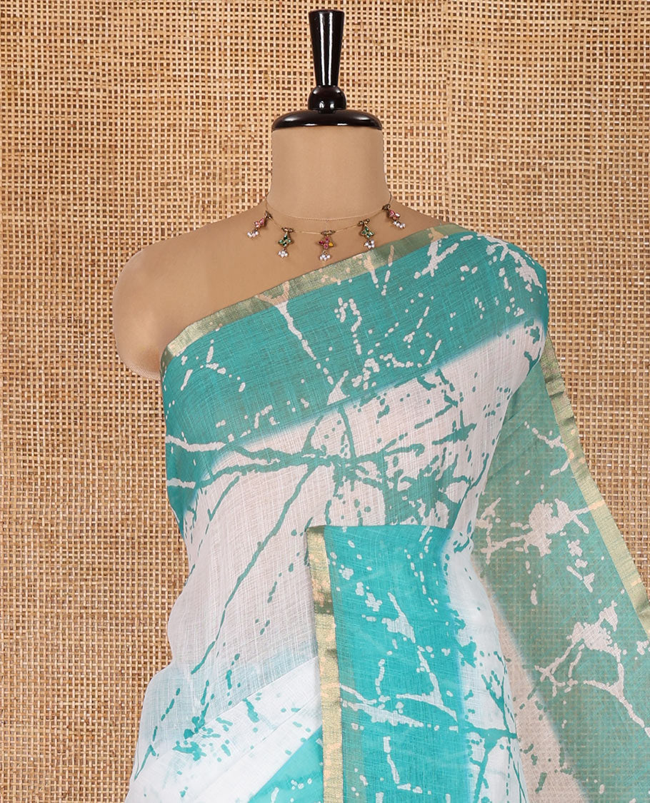 Cream and Rama Linen Cotton Saree, Decorated with Batik Print on Its Body, Complemented by Contrast Batik Printed Border, Pallu of Floral Print, and Paired with a Contrast Blouse